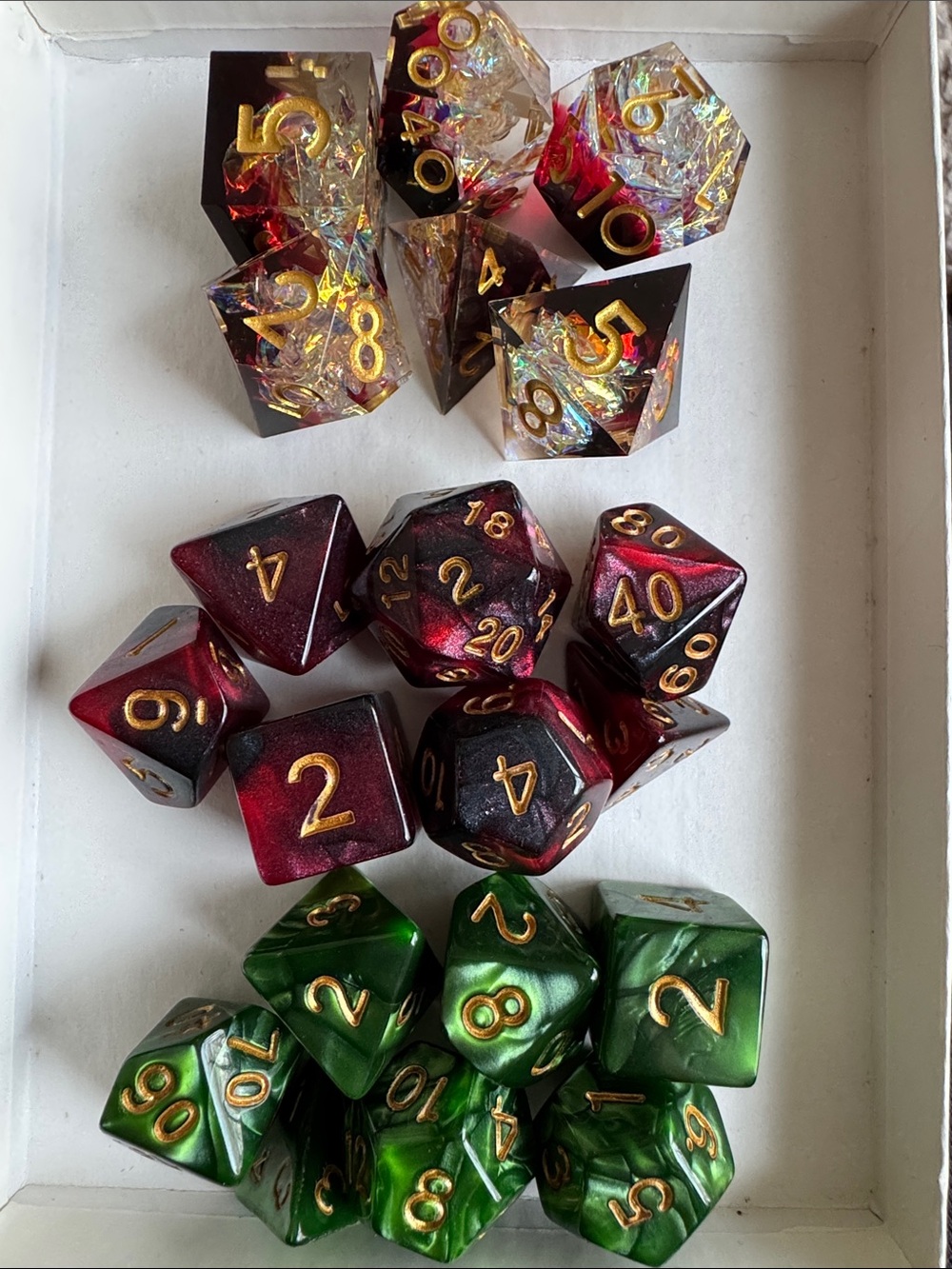 Set of Three 7-Piece RPG Dice Sets - Red, Green, and Iridescent